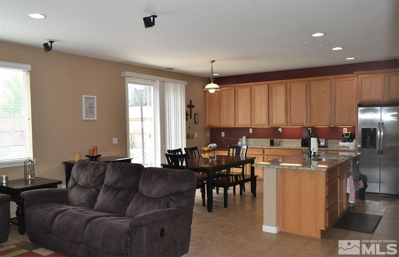 10675 Cedar Bend Court Reno, NV 89521 - Photo 9 of 22 a living room with furniture a large window and a dining table
