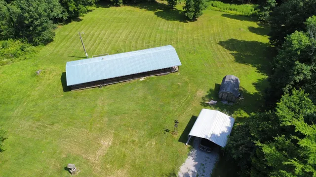 an aerial view of a house with a yard basket ball court and outdoor seating