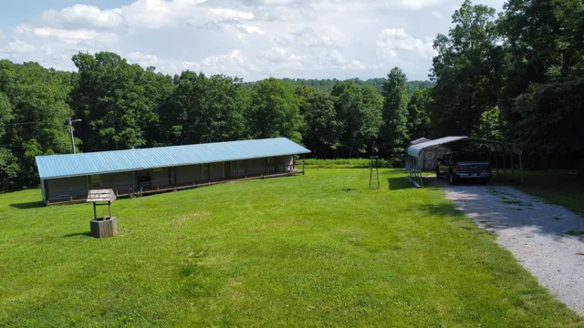 a view of a backyard with sitting area