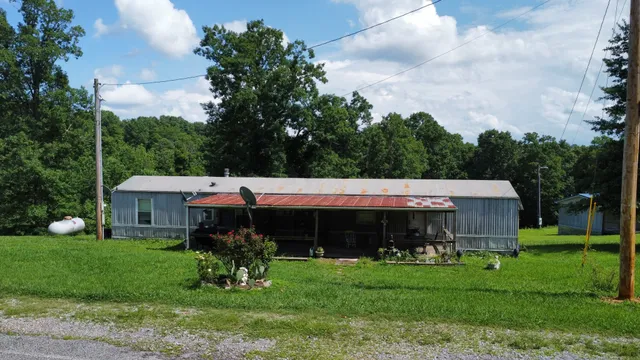 a view of a house with garden and a swimming pool