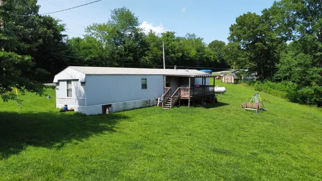 a view of a house with backyard and sitting area