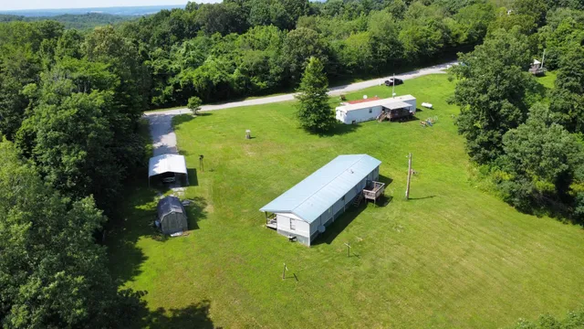 an aerial view of a house with a yard