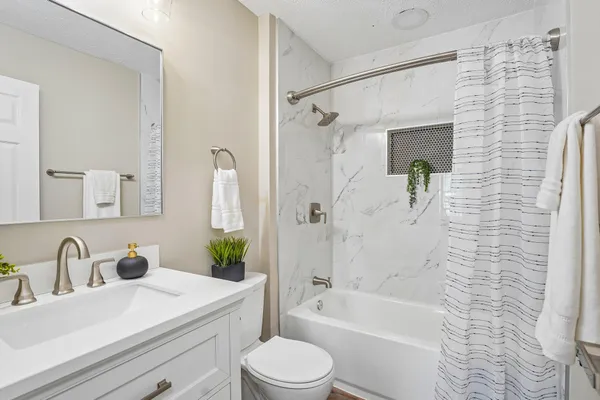 a bathroom with a sink toilet and shower