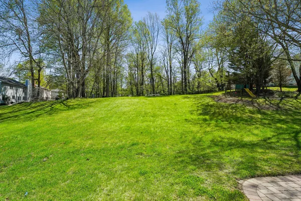 a big yard with lots of green space and trees