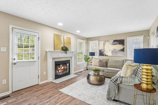a living room with furniture and a fireplace
