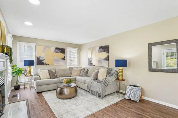 a living room with furniture and a wooden floor