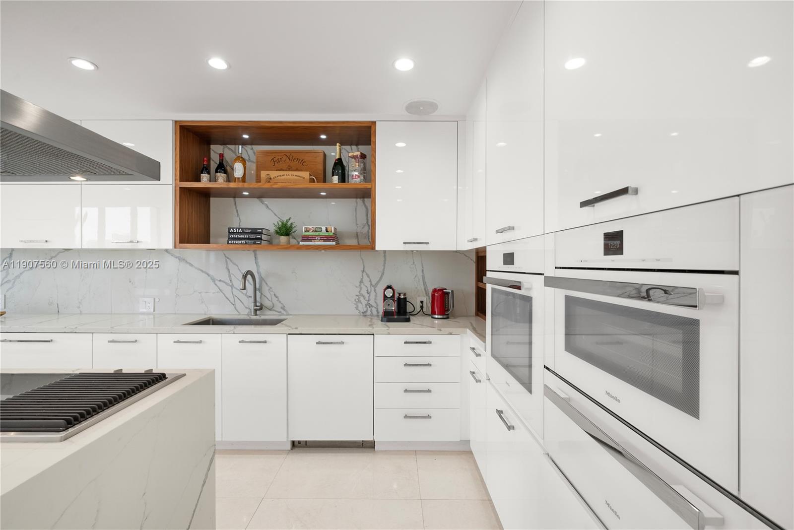 1925 Brickell Avenue, Unit DPH3 Miami, FL 33129 - Photo 12 of 56 a kitchen with white cabinets and appliances