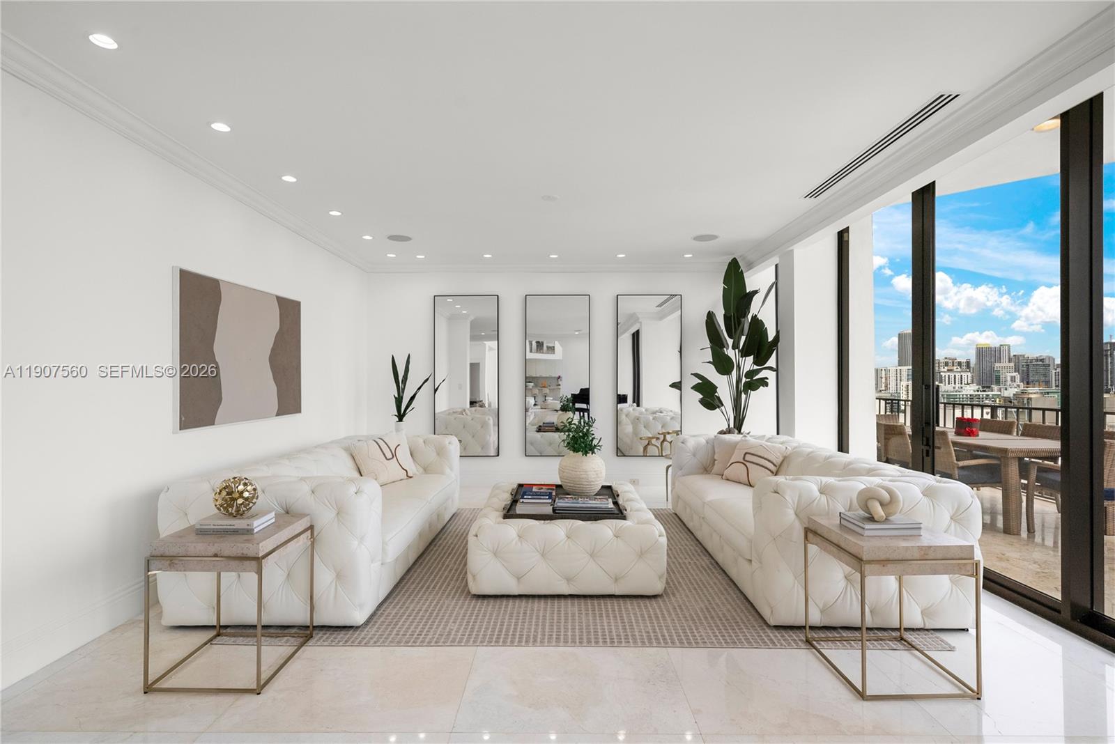 1925 Brickell Avenue, Unit DPH3 Miami, FL 33129 - Photo 18 of 56 a living room with furniture and a large window