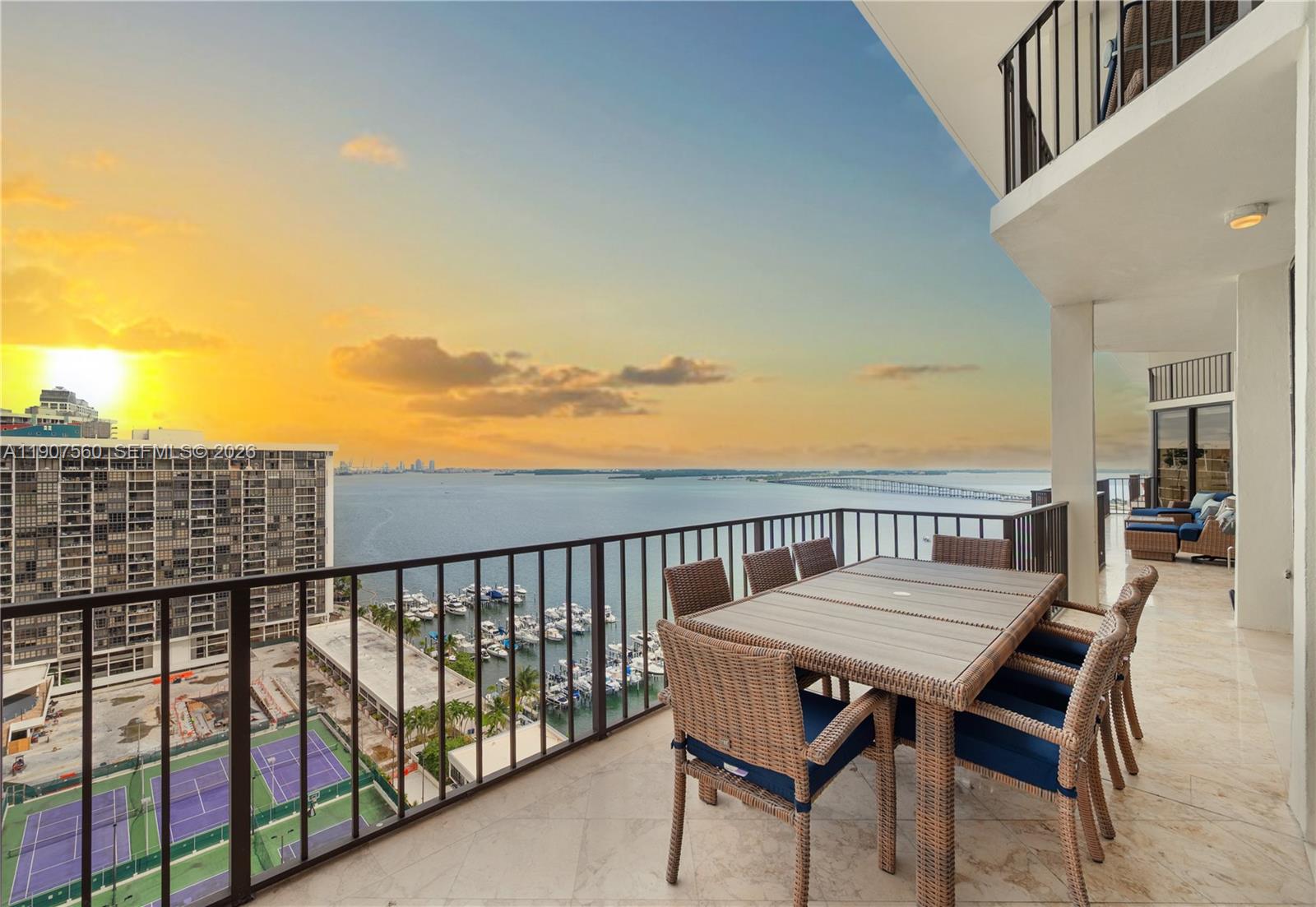 1925 Brickell Avenue, Unit DPH3 Miami, FL 33129 - Photo 19 of 56 a view of a balcony with wooden chairs