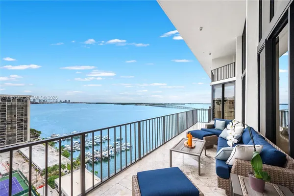 a balcony with chairs and a table