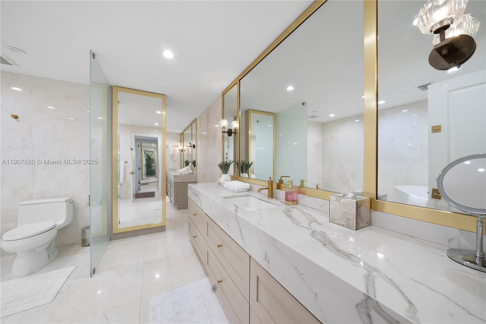 1925 Brickell Avenue, Unit DPH3 Miami, FL 33129 - Photo 33 of 56 a large bathroom with a large mirror vanity and toilet