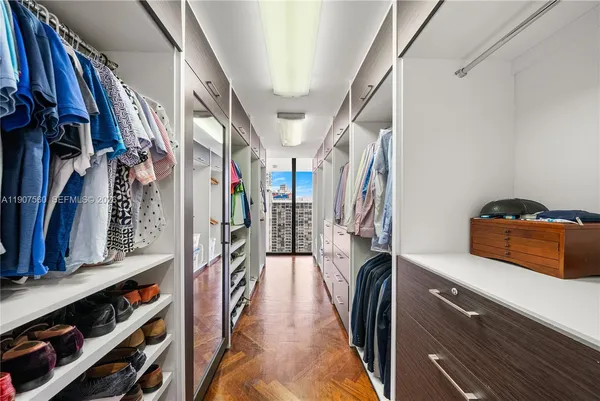 a large bedroom with a bed and large window