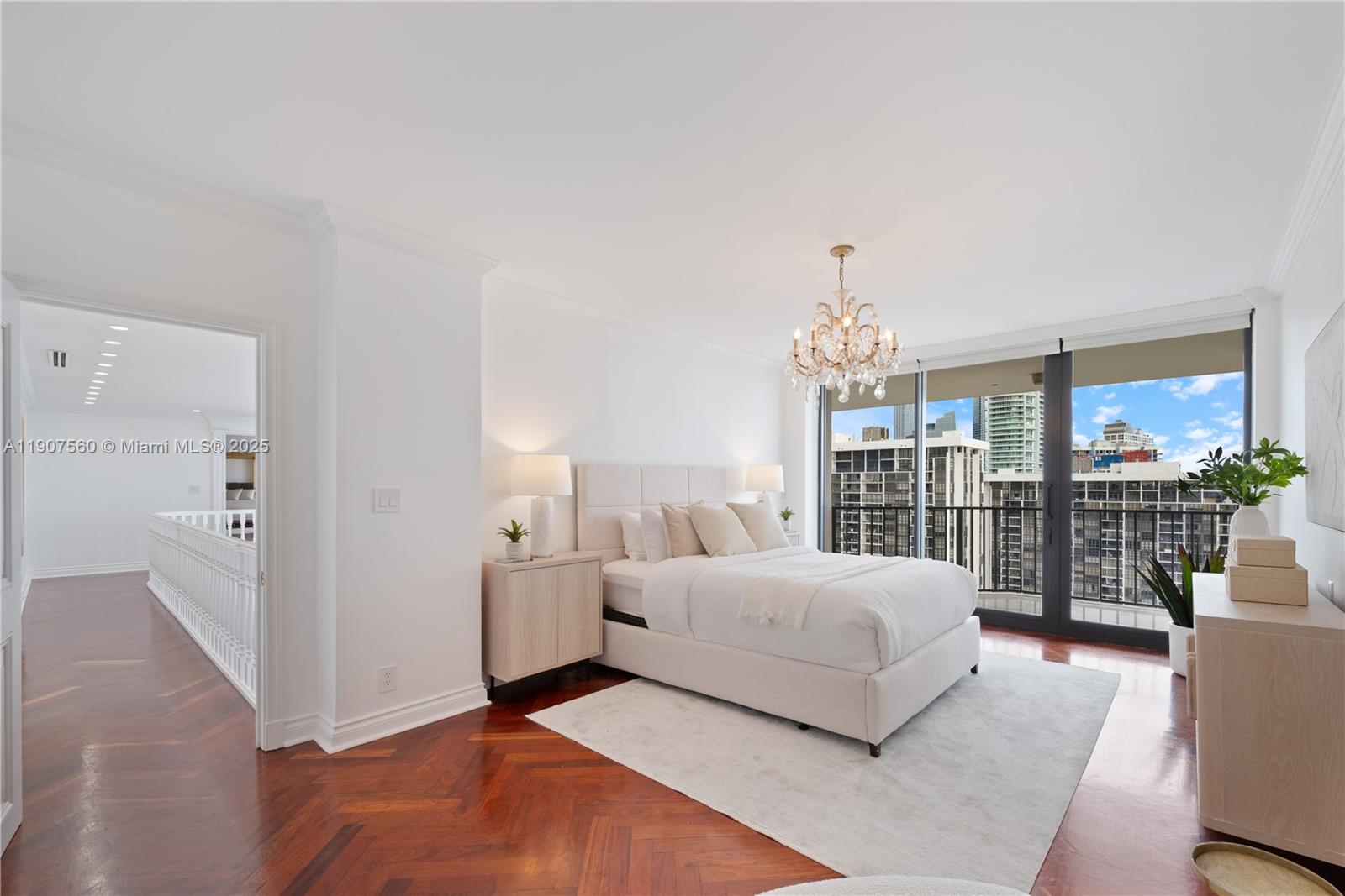 1925 Brickell Avenue, Unit DPH3 Miami, FL 33129 - Photo 38 of 56 a bedroom with a balcony a bed and a chandelier