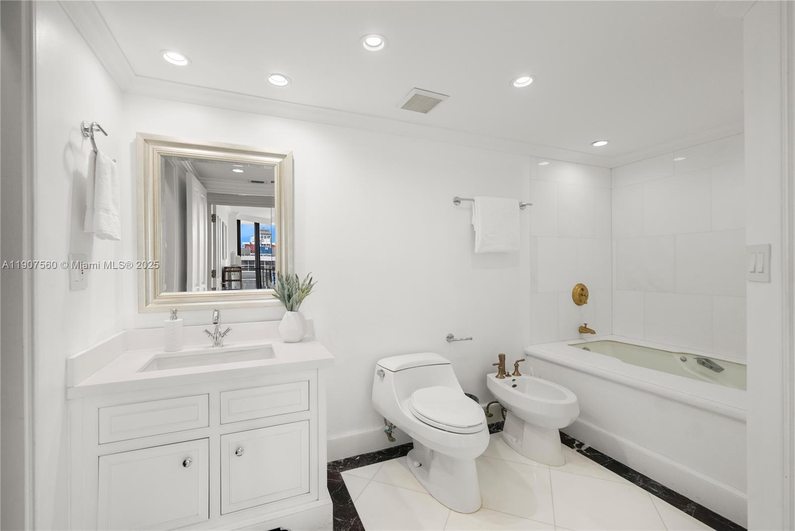 1925 Brickell Avenue, Unit DPH3 Miami, FL 33129 - Photo 43 of 56 a bathroom with a toilet sink and mirror