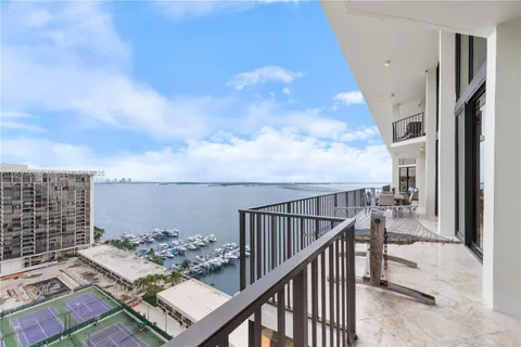 a view of a patio with a table and chairs under an umbrella