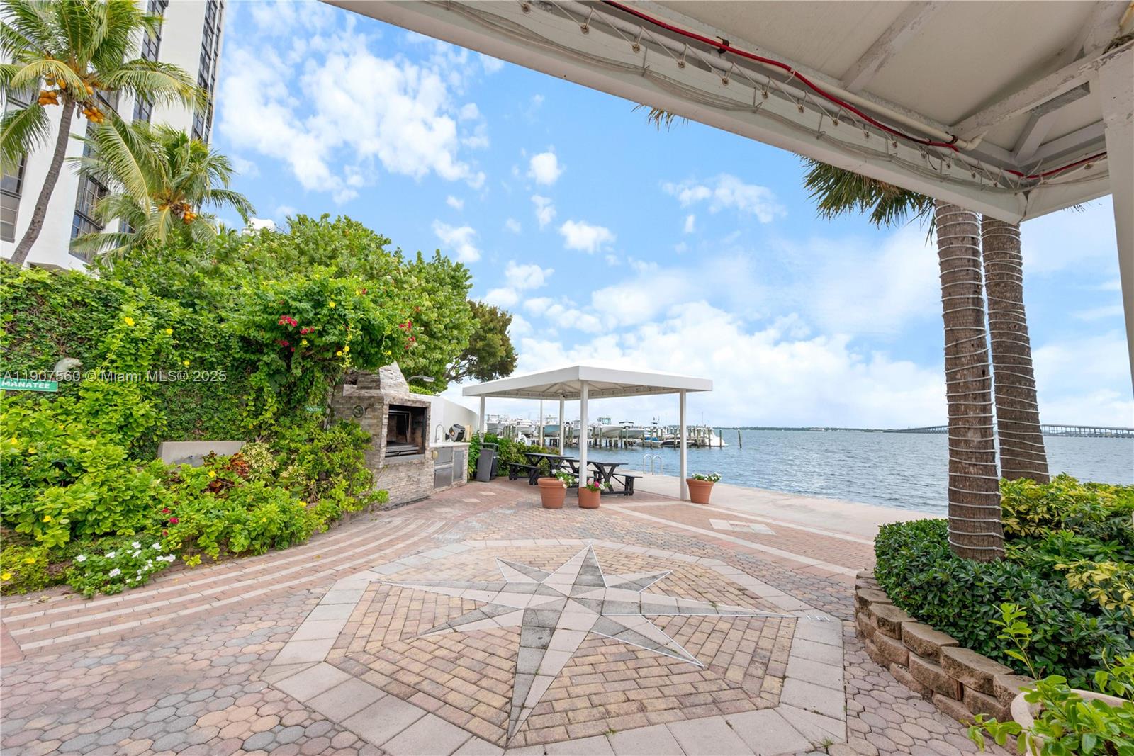 1925 Brickell Avenue, Unit DPH3 Miami, FL 33129 - Photo 52 of 56 a view of a patio with a table and chairs under an umbrella