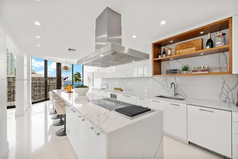 a dining room with furniture and a floor to ceiling window