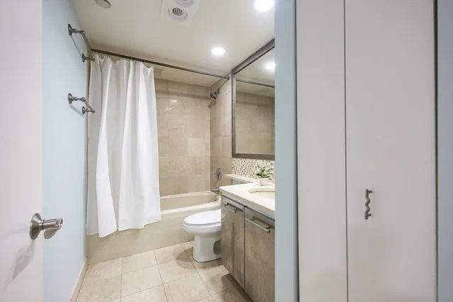 a bathroom with a toilet sink and shower