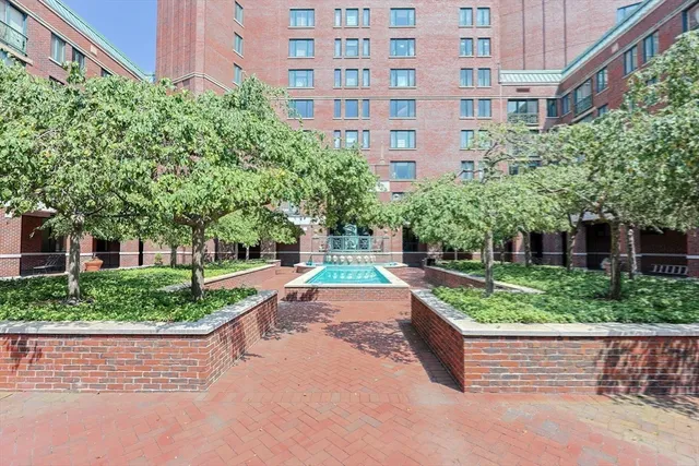 a view of a swimming pool and outdoor seating