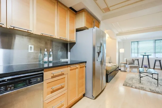 a kitchen with stainless steel appliances granite countertop a refrigerator and a stove