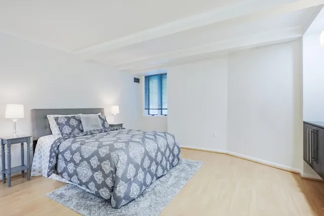 a bedroom with a bed and a night stand