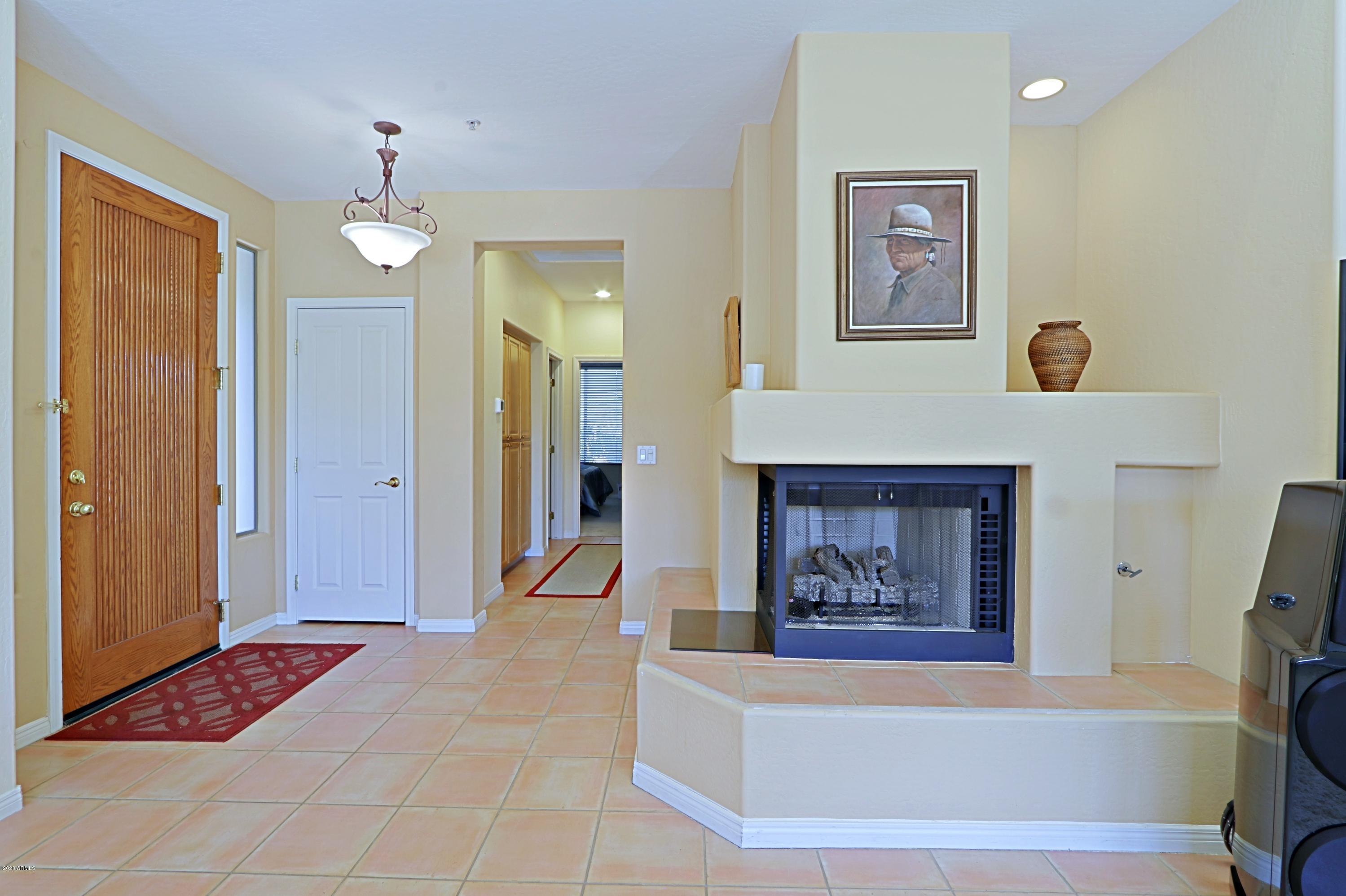 6803 East Eagle Feather Road Scottsdale, AZ 85266 - Photo 7 of 67 a view of a hallway with cabinet and a chandelier