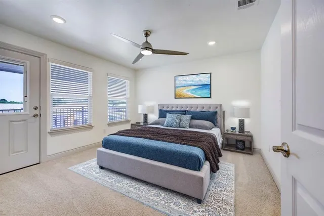 a spacious bedroom with a bed and a chandelier