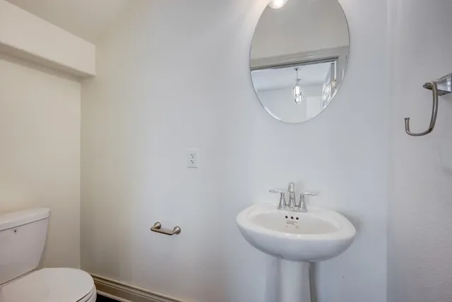 a bathroom with a sink a mirror and a toilet