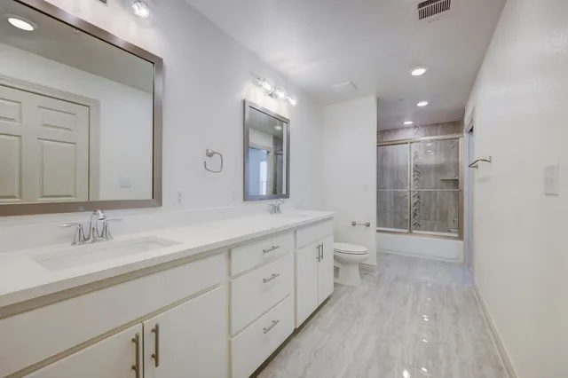 a bathroom with a double vanity sink and mirror