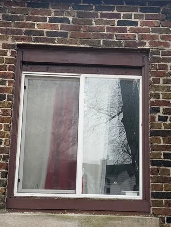 a brick building with a bench in front of it