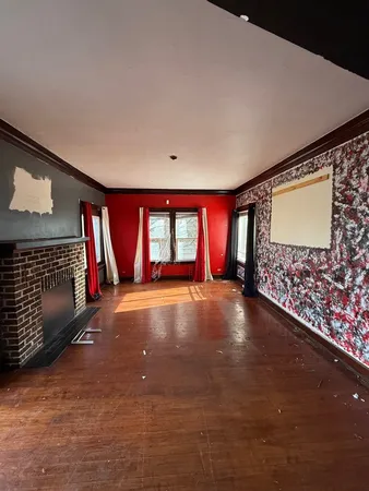 a view of empty room with window and fireplace