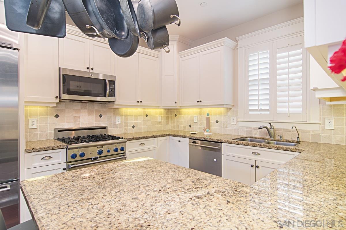 918 D Avenue Coronado, CA 92118 - Photo 12 of 41 a kitchen with a stove a sink and a microwave