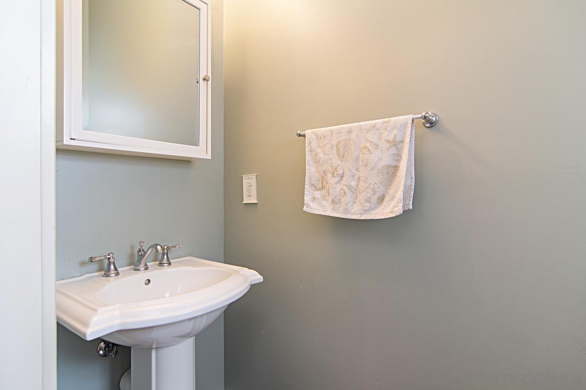 918 D Avenue Coronado, CA 92118 - Photo 14 of 41 a bathroom with a sink and a mirror
