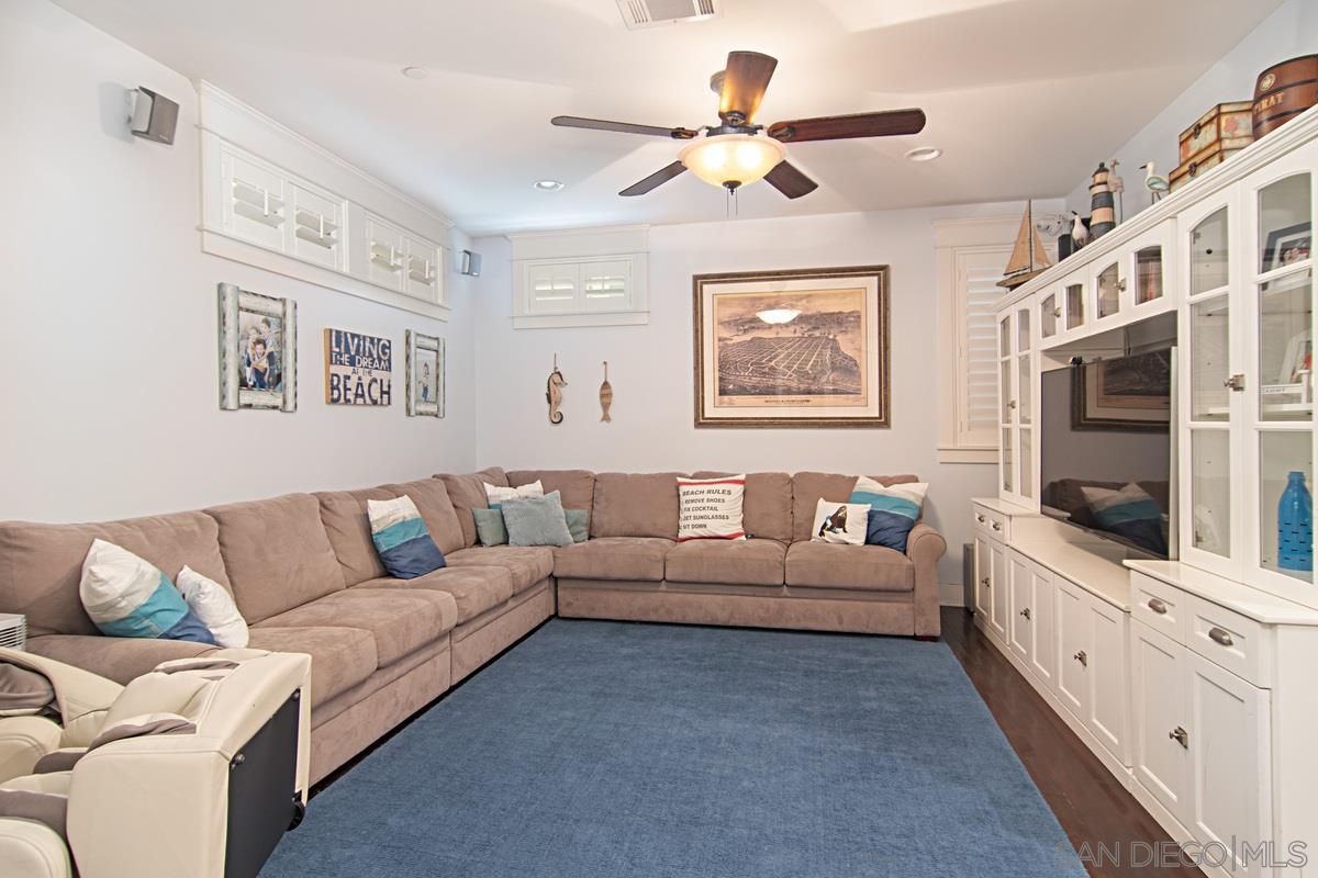 918 D Avenue Coronado, CA 92118 - Photo 16 of 41 a living room with furniture flat screen tv and a ceiling fan