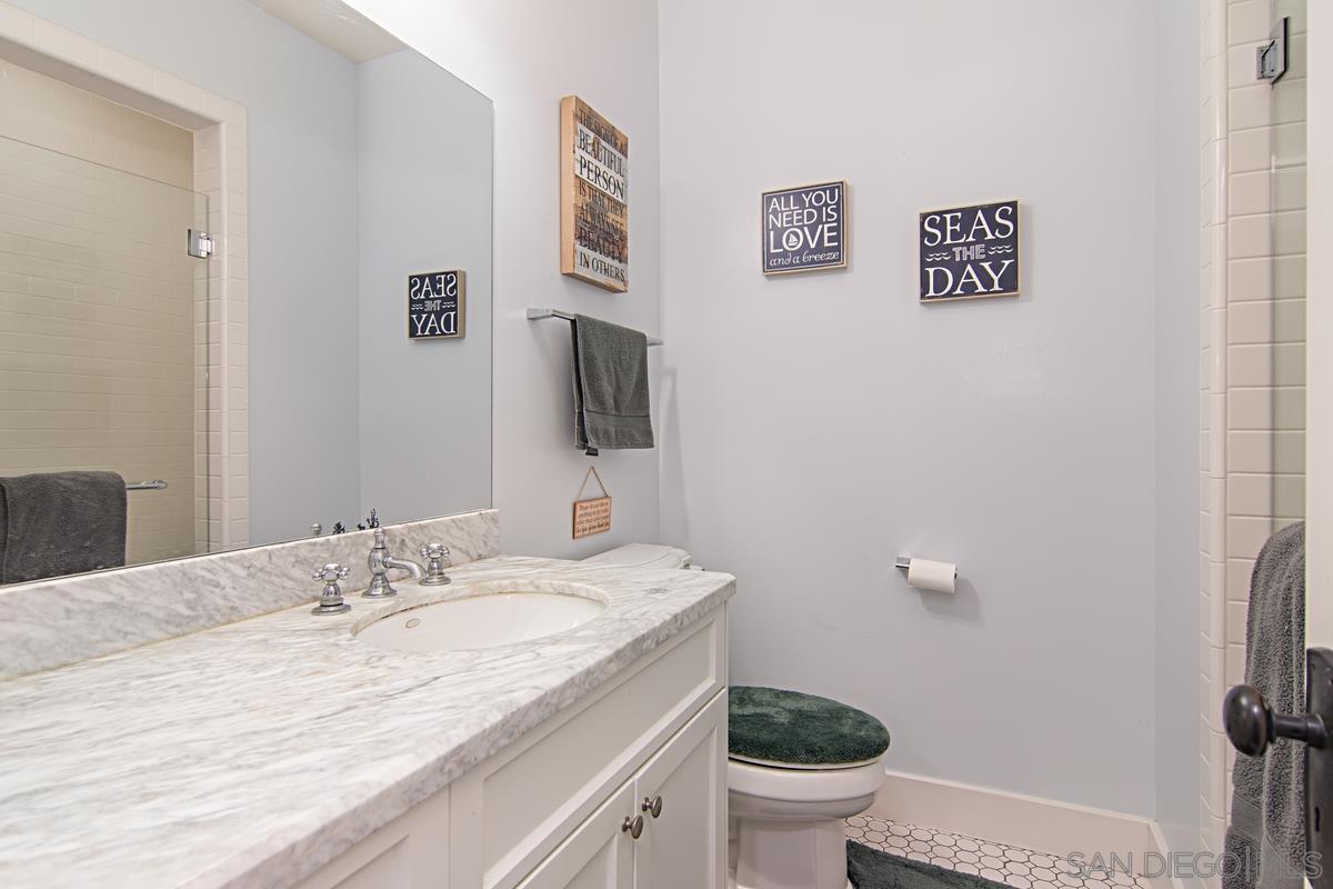 918 D Avenue Coronado, CA 92118 - Photo 20 of 41 a bathroom with a granite countertop sink toilet and a mirror