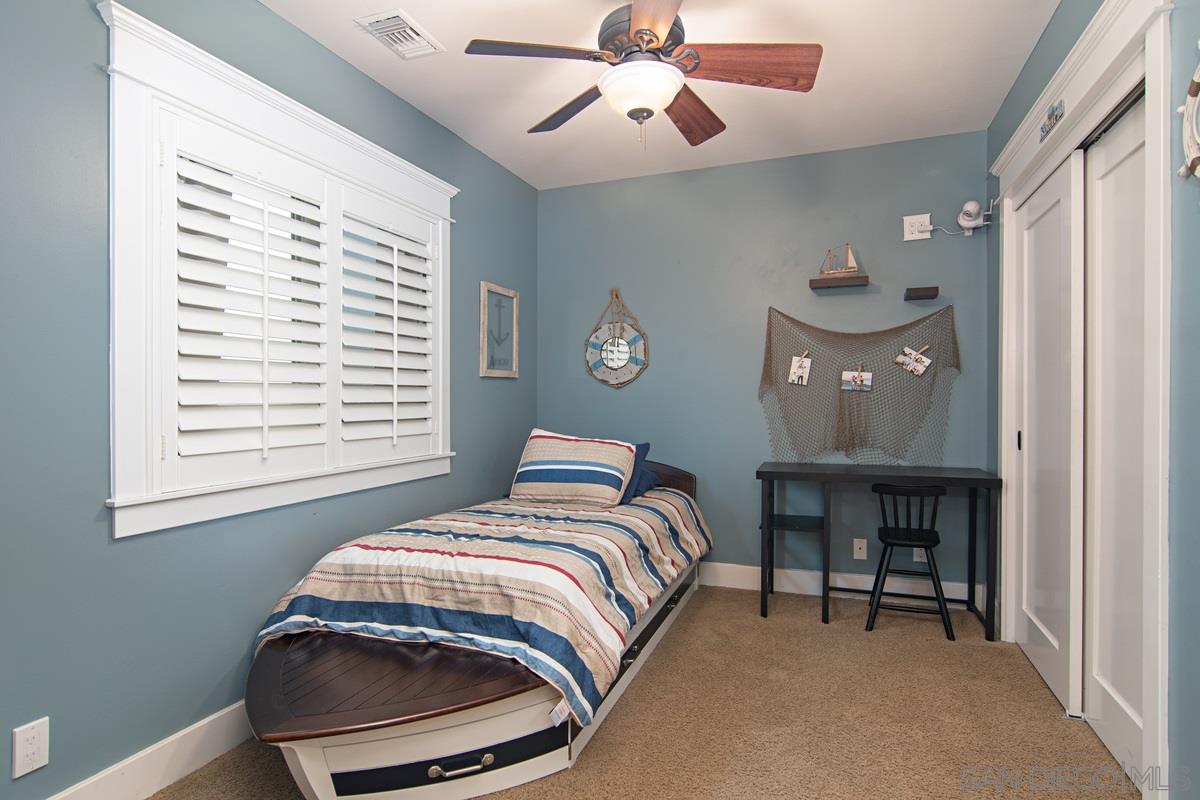 918 D Avenue Coronado, CA 92118 - Photo 28 of 41 a bedroom with a bed and a table in it