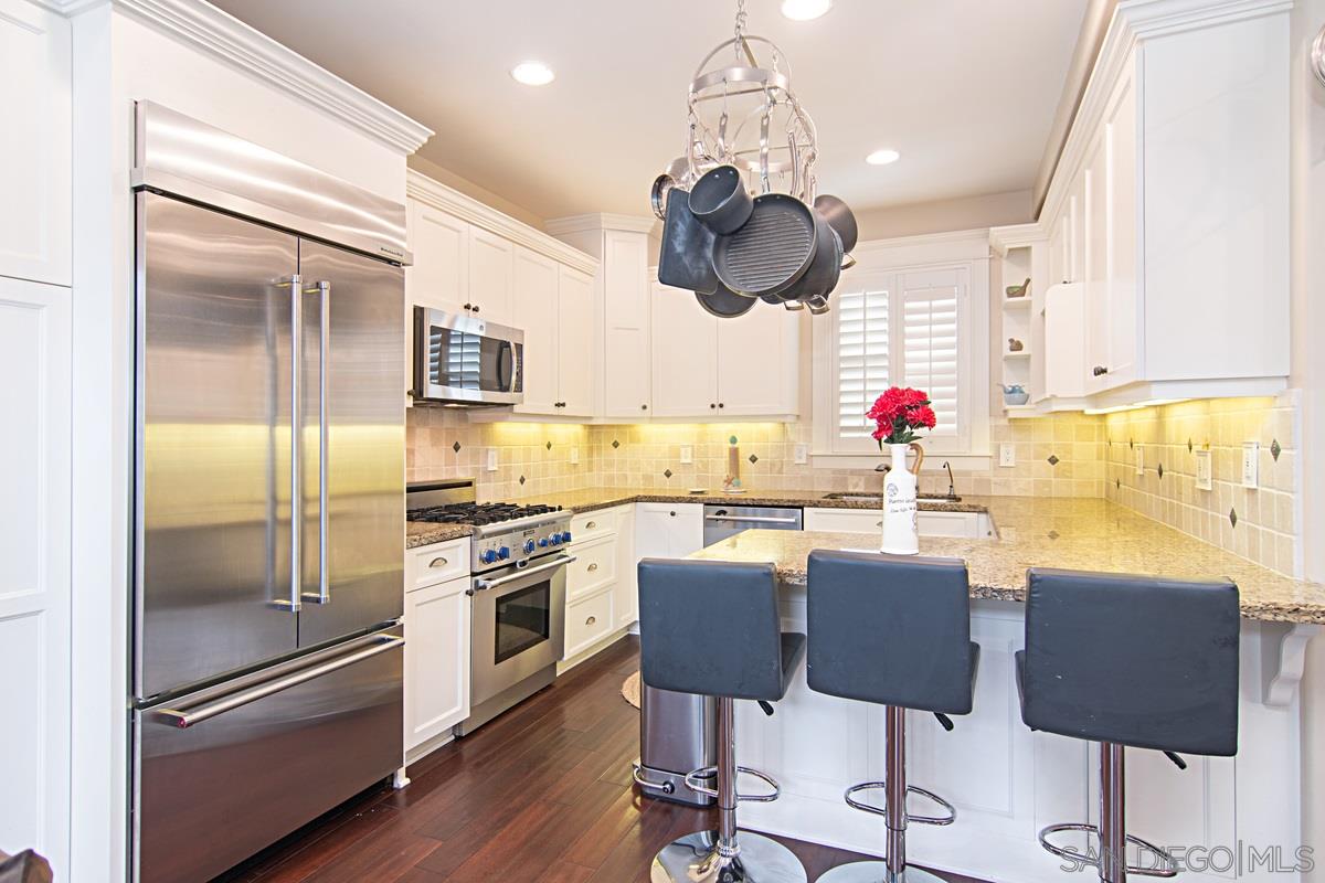 918 D Avenue Coronado, CA 92118 - Photo 9 of 41 a kitchen with stainless steel appliances granite countertop a refrigerator and a stove top oven