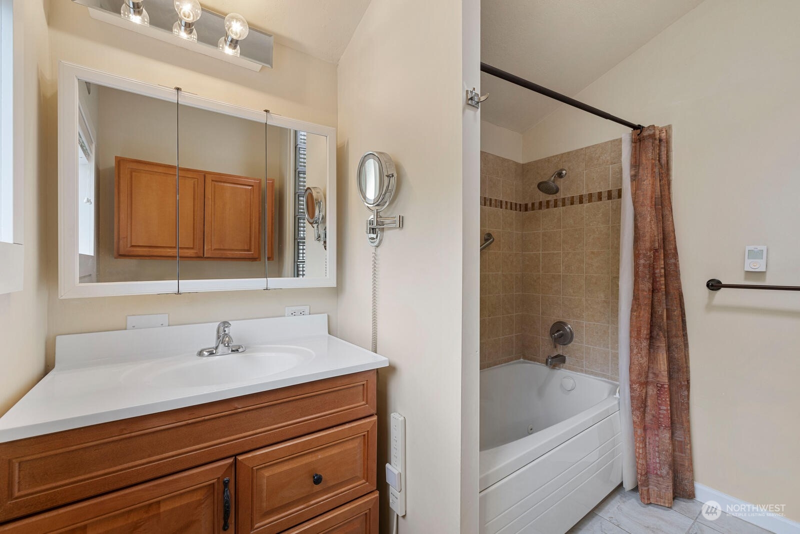 7524 Maxwelton Road Clinton, WA 98236 - Photo 16 of 30 a bathroom with a tub sink shower and mirror