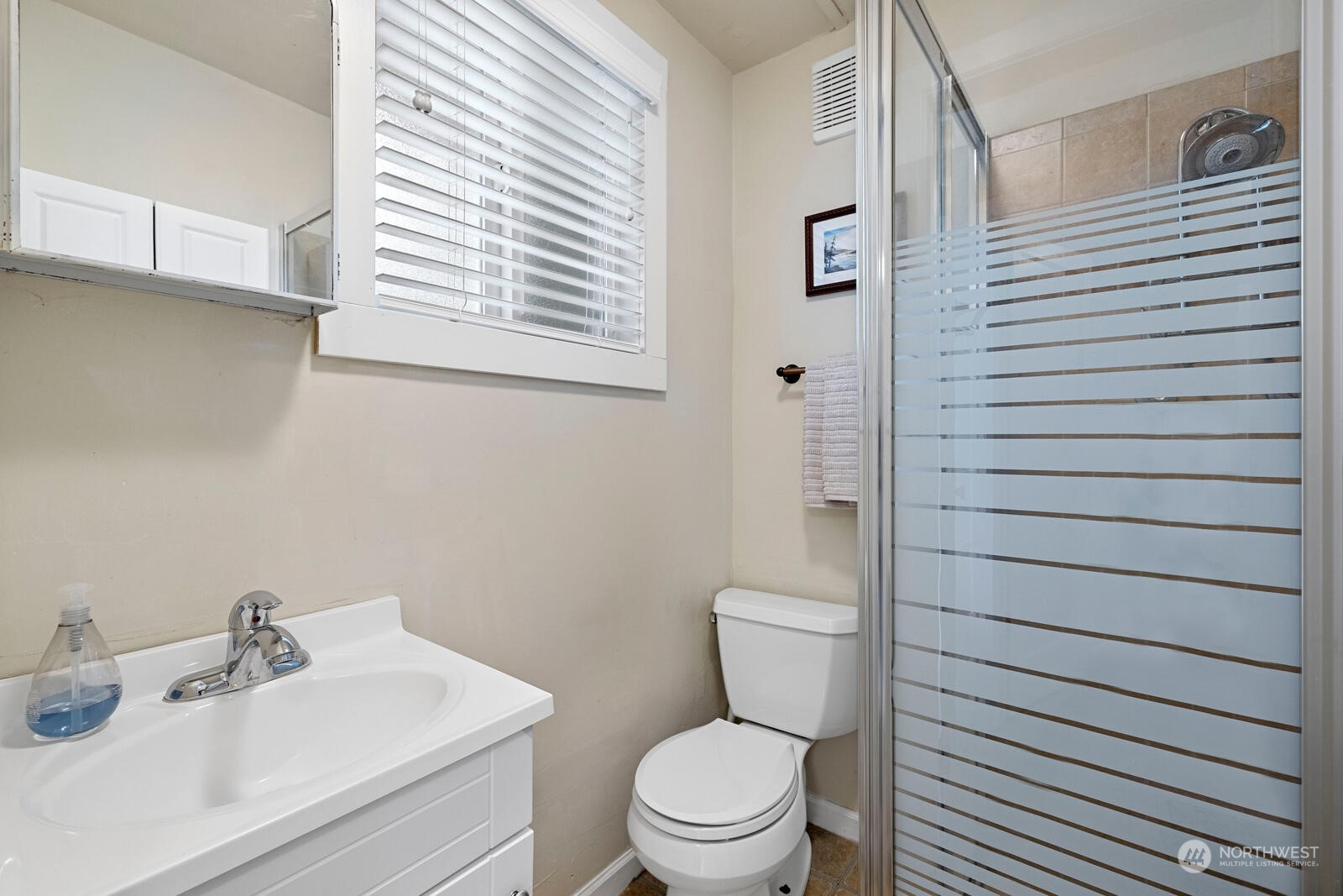 7524 Maxwelton Road Clinton, WA 98236 - Photo 25 of 30 a bathroom with a toilet a sink and a window