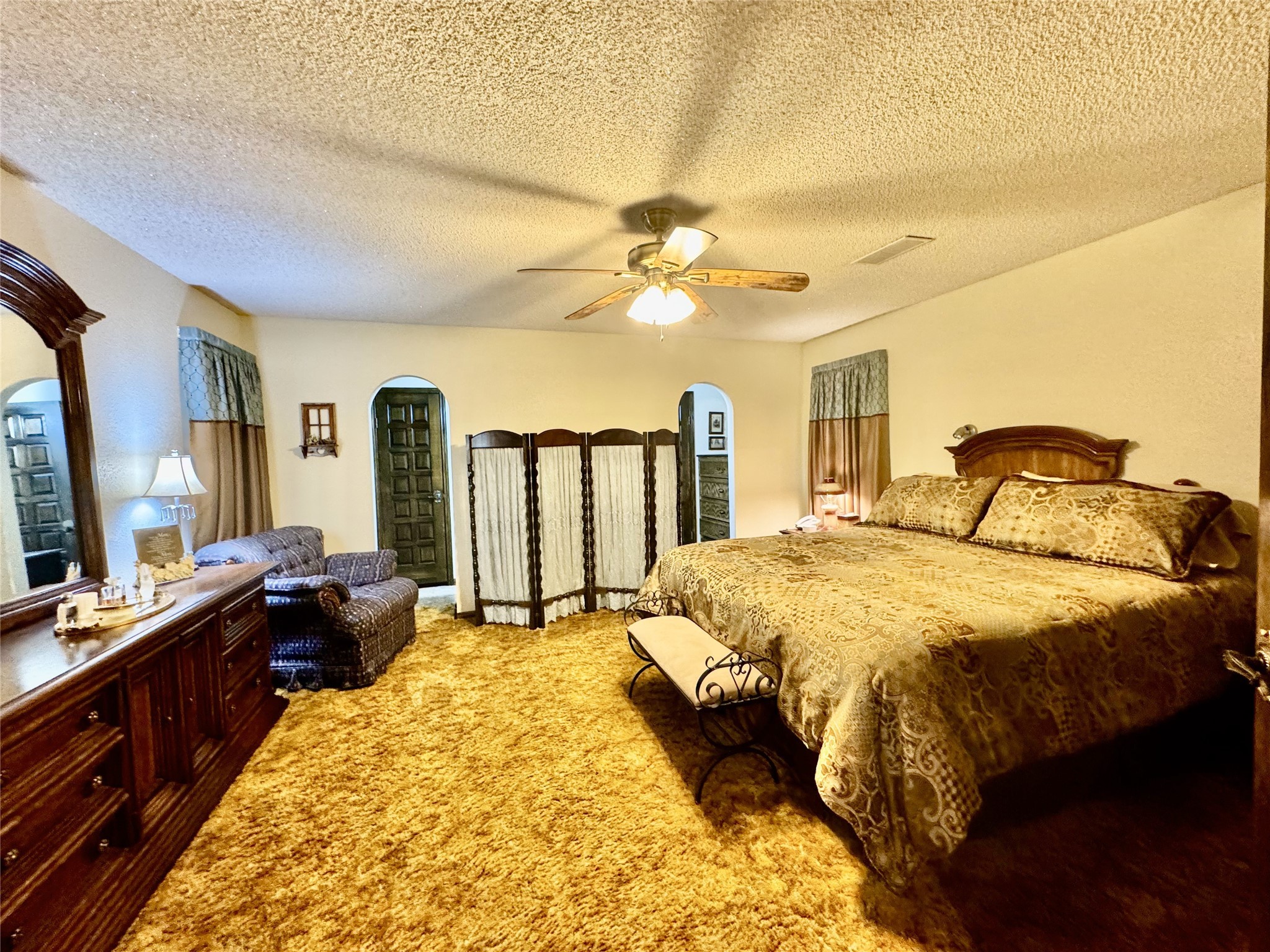 11586 Midway Road Cleveland, TX 77328 - Photo 7 of 37 a spacious bedroom with a bed and wooden floor
