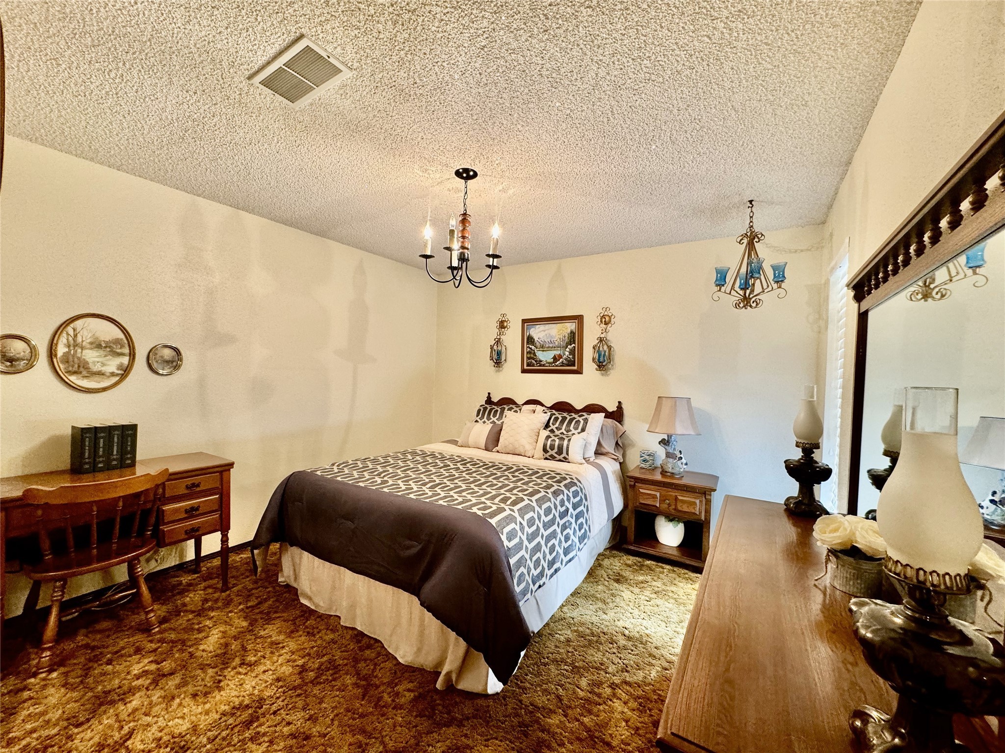 11586 Midway Road Cleveland, TX 77328 - Photo 9 of 37 a bedroom with a bed and a chandelier