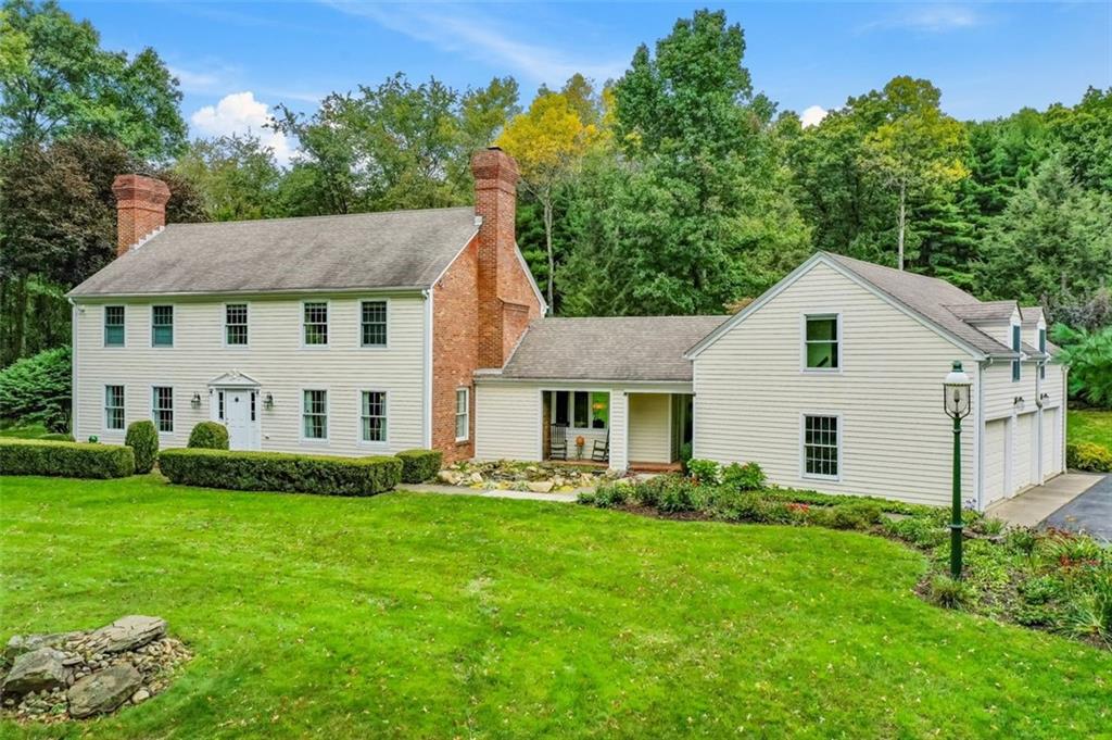 a front view of house with yard and green space