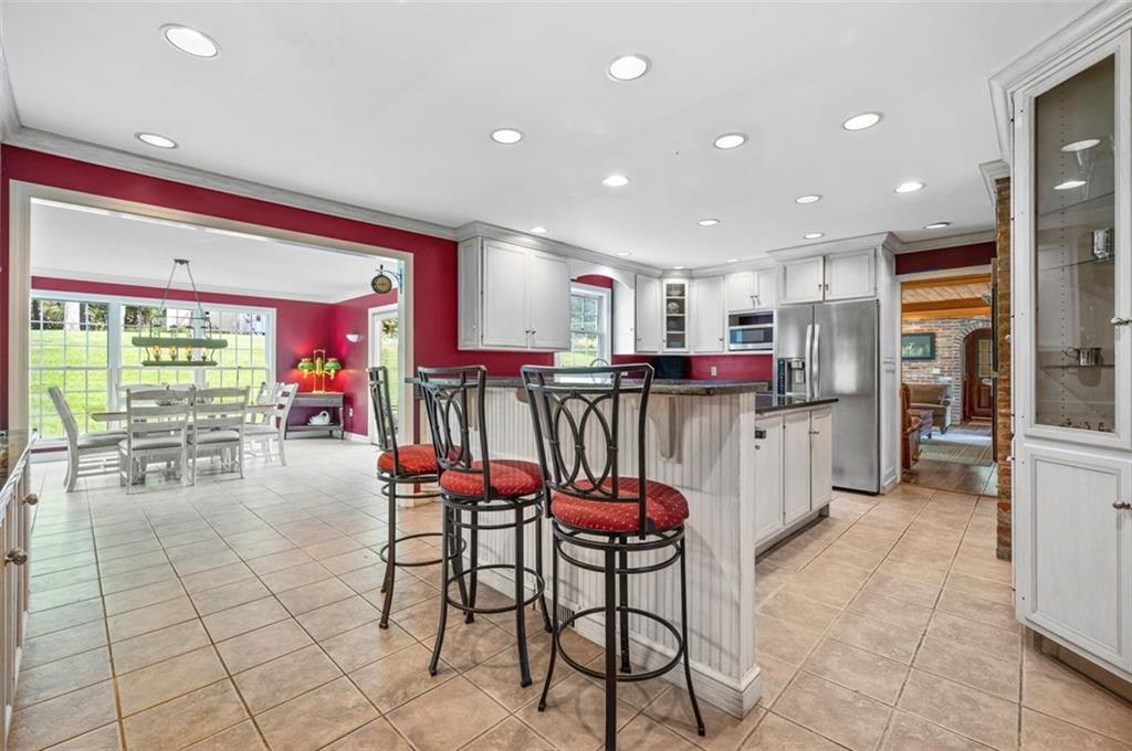 2375 Fairhill Farms Road Sewickley, PA 15143 - Photo 8 of 25 a kitchen with stainless steel appliances kitchen island granite countertop a refrigerator and cabinets