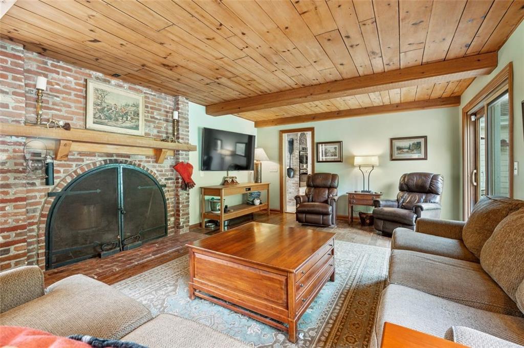 2375 Fairhill Farms Road Sewickley, PA 15143 - Photo 10 of 25 a living room with furniture a fireplace and a flat screen tv