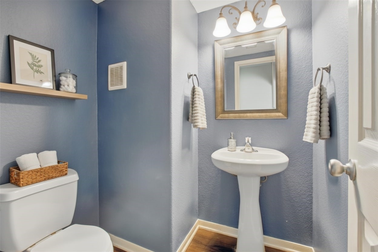 1193 Stallion Ridge Alvin, TX 77511 - Photo 7 of 14 a bathroom with a toilet sink and mirror