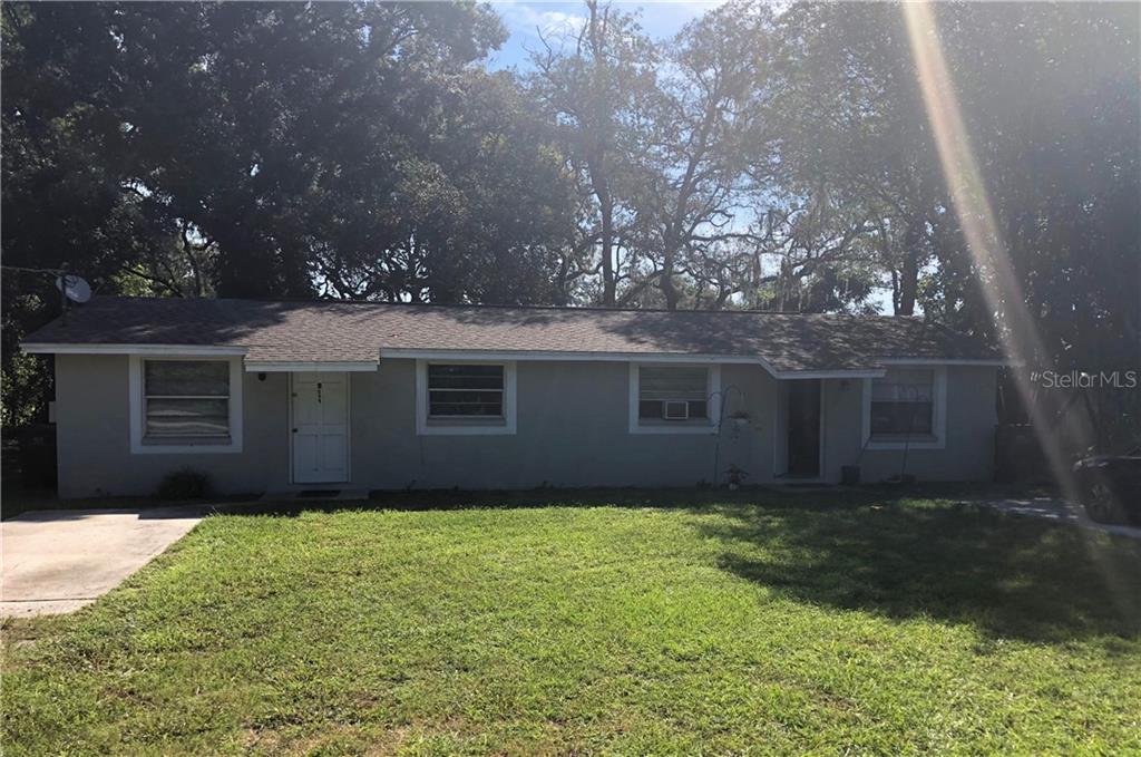507 Meade Street Brandon, FL 33510 - Photo 1 of 1 a front view of house with yard and trees in the background