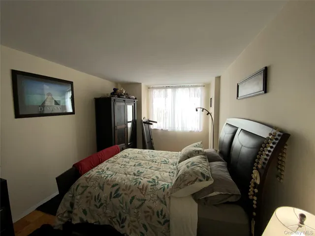 a bedroom with a bed and mirror
