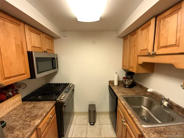 a kitchen that has a sink and a stove
