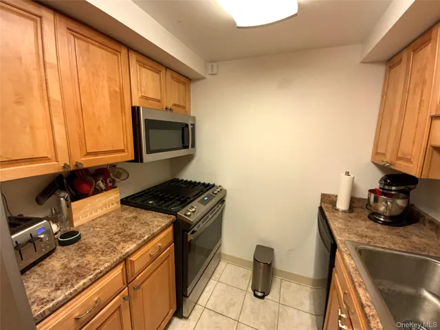 a kitchen with a stove a sink and a microwave