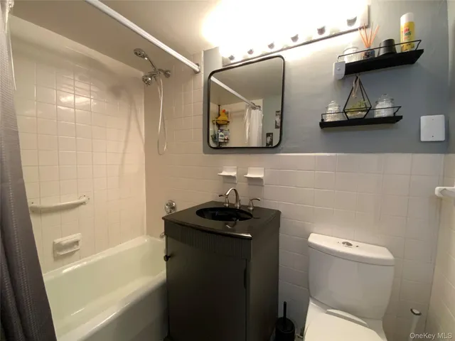 a bathroom with a sink and mirror with toilet
